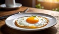 Close-up of sunny-side-up egg on white ceramic plate, wooden table, morning light Royalty Free Stock Photo