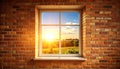Exposed brick wall with tall window, warm golden sunlight, summer sky Royalty Free Stock Photo