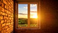 Exposed brick wall with tall window, warm golden sunlight, summer sky Royalty Free Stock Photo