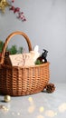 Wicker basket with gift set and Christmas decor on grey table. Space for text Royalty Free Stock Photo