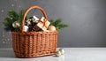 Wicker basket with gift set and Christmas decor on grey table. Space for text Royalty Free Stock Photo