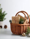 Wicker basket with gift set and Christmas decor on grey table. Space for text Royalty Free Stock Photo