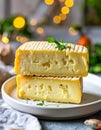 Two slices of havarti with visible texture on white ceramic plate soft bokeh background Royalty Free Stock Photo
