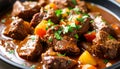 Close-up of beef stew chunks in sauce macro detail soft background blur Royalty Free Stock Photo