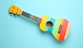 Colorful ukulele on light blue background, top view. String musical instrument Royalty Free Stock Photo