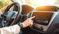 Listening to radio while driving. Woman turning volume button on vehicle audio in car Royalty Free Stock Photo
