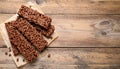 Delicious chocolate puffed rice bars on wooden table, flat lay. Space for text Royalty Free Stock Photo