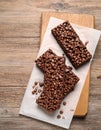 Delicious chocolate puffed rice bars on wooden table, flat lay. Space for text Royalty Free Stock Photo
