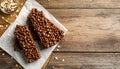 Delicious chocolate puffed rice bars on wooden table, flat lay. Space for text Royalty Free Stock Photo