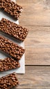 Delicious chocolate puffed rice bars on wooden table, flat lay. Space for text Royalty Free Stock Photo
