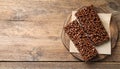 Delicious chocolate puffed rice bars on wooden table, flat lay. Space for text Royalty Free Stock Photo