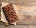 Delicious chocolate puffed rice bars on wooden table, flat lay. Space for text Royalty Free Stock Photo