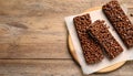Delicious chocolate puffed rice bars on wooden table, flat lay. Space for text Royalty Free Stock Photo