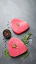 Raw tuna fillets with herbs and spices on gray table, flat lay. Space for text Royalty Free Stock Photo