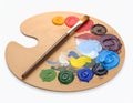Wooden artist\'s palette with mixed paints and brush isolated on white Royalty Free Stock Photo