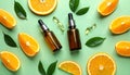 Skincare ampoules with vitamin C, slices of orange and leaves on light green bnd Royalty Free Stock Photo