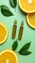 Skincare ampoules with vitamin C, slices of orange and leaves on light green bnd Royalty Free Stock Photo