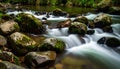 River Stream Over Rounded Stones with Blurred Background Royalty Free Stock Photo
