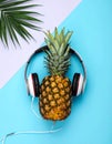 Flat lay composition with pineapple and headphones on color background Royalty Free Stock Photo
