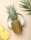 Flat lay composition with pineapple and headphones on color background Royalty Free Stock Photo