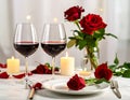 Romantic table setting with glasses of red wine, rose flowers and burning candles Royalty Free Stock Photo