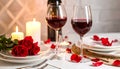 Romantic table setting with glasses of red wine, rose flowers and burning candles Royalty Free Stock Photo