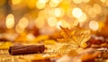 Golden autumn leaf bokeh with single cinnamon stick in bottom-left corner Royalty Free Stock Photo