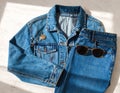 Blue Denim Jacket and Jeans with Sunglasses in Casual Fashion Flat Lay Royalty Free Stock Photo
