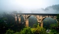 Ancient Stone Arch Bridge Covered in Morning Fog Royalty Free Stock Photo