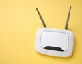 New white Wi-Fi router on yellow background, space for text Royalty Free Stock Photo