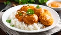 generated using AI.A plate of white rice topped with four golden-brown patties covered in a rich, thick peanut sauce. Royalty Free Stock Photo