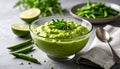 generated using AI.A glass bowl with creamy green pea dip, garnished with fresh herbs, sits on a gray surface. Royalty Free Stock Photo