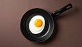 generated using AI.Frying pan with a single sunny-side-up egg, featuring a bright yellow yolk centered in white cooked egg whites. Royalty Free Stock Photo