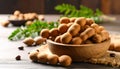 generated using AI.A wooden bowl filled with tamarind pods (Tamarindus indica) rests on a dark wooden surface. Royalty Free Stock Photo