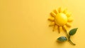 Tiny sun model on matte pale yellow background symbolizing energy Royalty Free Stock Photo
