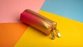generated using AI.Rectangular pencil case with a gradient design, transitioning from gold to pink. Royalty Free Stock Photo
