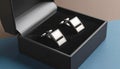 generated using AI.A pair of silver cufflinks with a sleek, rectangular design is set in a black velvet-lined display case. Royalty Free Stock Photo