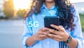 Woman using smartphone with 5G network system outdoors, closeup. Royalty Free Stock Photo
