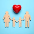 Paper family figures and red heart on light blue background, flat lay. Insurance Royalty Free Stock Photo