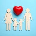 Paper family figures and red heart on light blue background, flat lay. Insurance Royalty Free Stock Photo