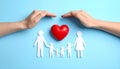 Paper family figures and red heart on light blue background, flat lay. Insurance Royalty Free Stock Photo