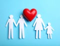 Paper family figures and red heart on light blue background, flat lay. Insurance Royalty Free Stock Photo