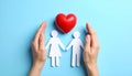Paper family figures and red heart on light blue background, flat lay. Insurance Royalty Free Stock Photo
