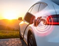 Modern electric car being charged at the outstation. Round pulse waves representing Royalty Free Stock Photo