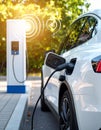 Modern electric car being charged at the outstation. Round pulse waves representing Royalty Free Stock Photo