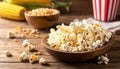Delicious popcorn and corn kernels on a wooden table. Royalty Free Stock Photo