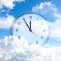 Time concept. Double exposure of blue sky with fluffy clouds and clock Royalty Free Stock Photo