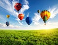 Dream world. Hot air balloons in sky with clouds over green meadow Royalty Free Stock Photo