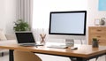 Modern computer and laptop on wooden desk in room. Interior design Royalty Free Stock Photo