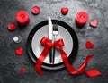 Romantic place setting with candles and red ribbon on dark gray textured table, flat lay Royalty Free Stock Photo